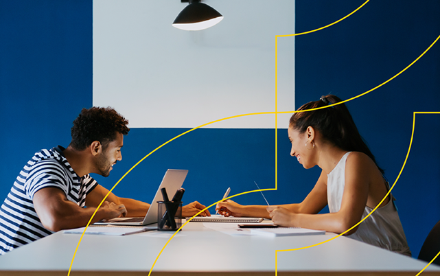 a man and a woman looking at a laptop