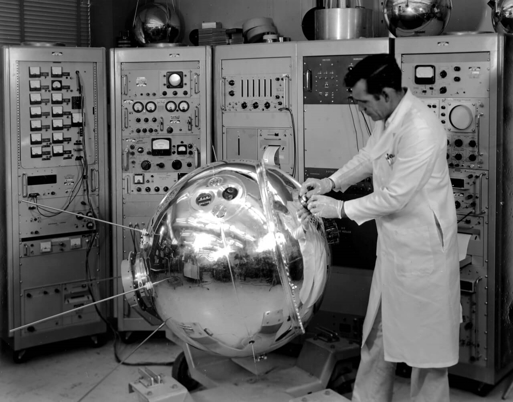 a person in a white coat working in a factory