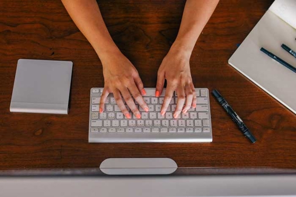 a person typing on a keyboard