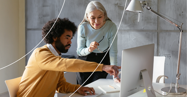 a man and a woman looking at a computer screen