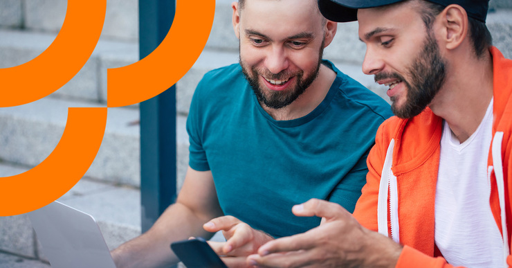 a couple of men looking at a phone